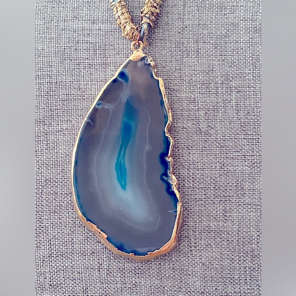 Serafina Jewelry - Serafina geode slab in gold tone on a suede cord. Commonly sold at Anthropologie